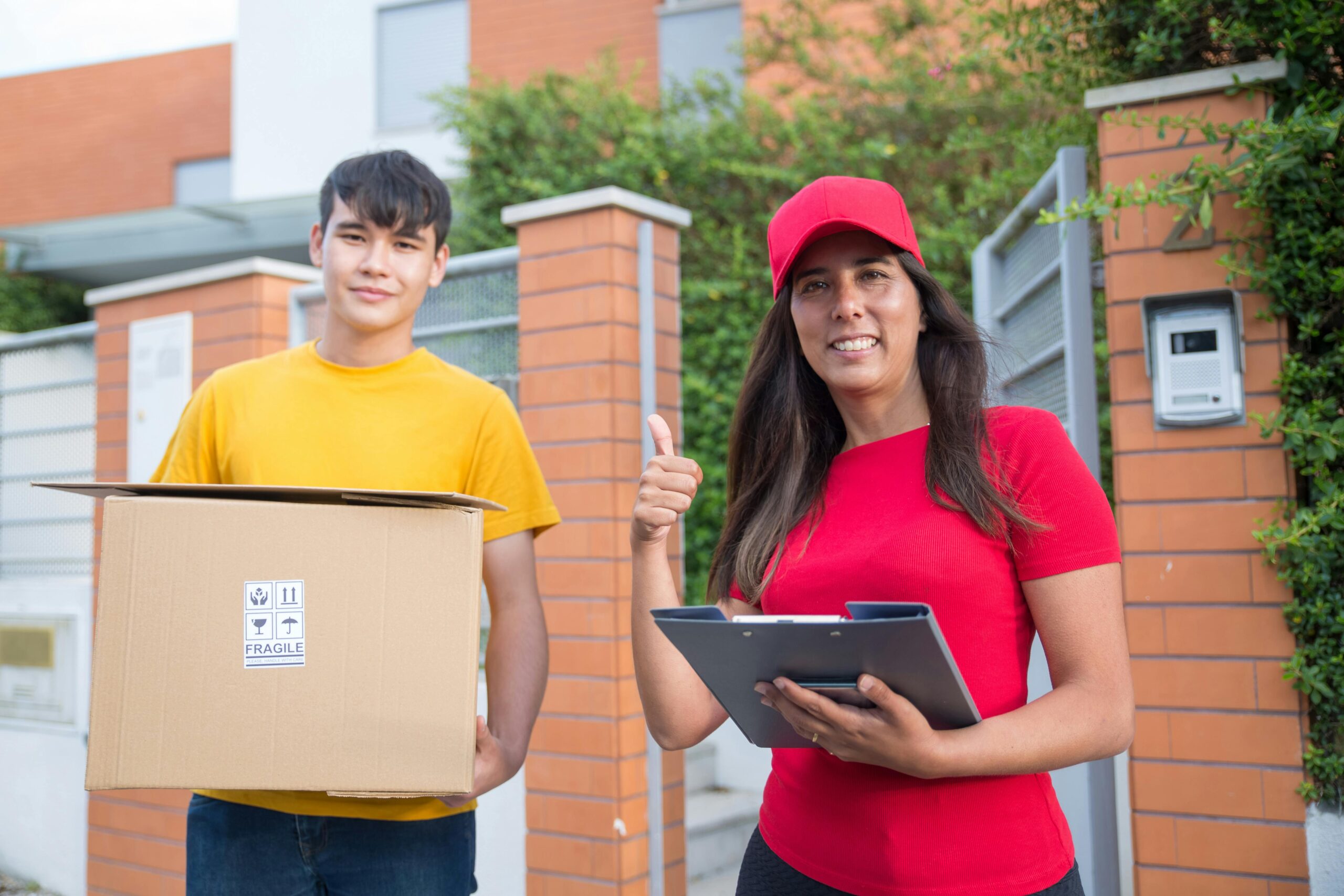 Smiling courier delivering a package to customer in Portugal, showing thumbs up gesture.